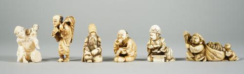 A group of six Japanese ivory netsuke, late 19th/early 20th century, comprising; a man with a monkey; a man eating fruit; a bearded Immortal; a man wi