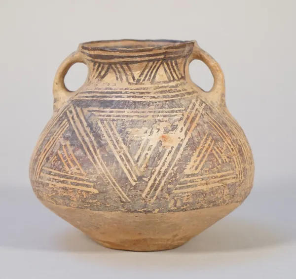 A small Chinese red earthenware two-handled vase, Neolithic period, circa 3rd century BC, painted with a stylised design, 13cm high.