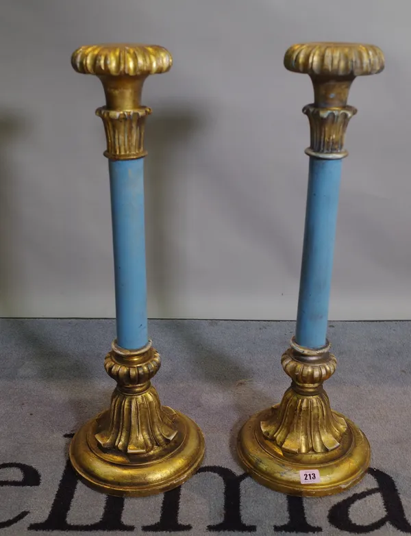 A pair of parcel gilt blue painted Rococo Revival candlesticks, 67cm high x 12cm diameter at base, (2).