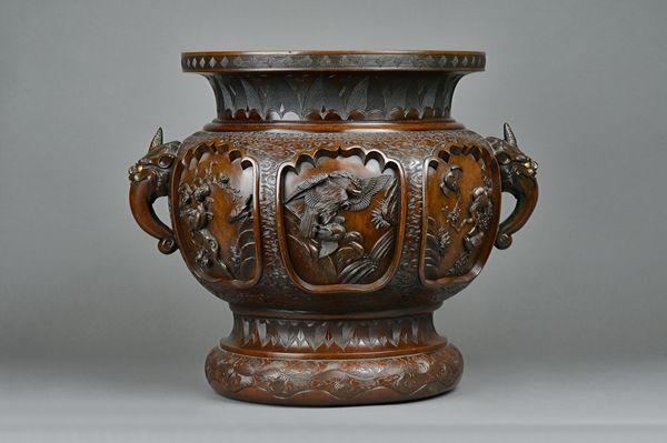 A good and large bronze jardiniere, probably Chinese, late 19th century, deeply cast with six shaped panels enclosing birds between incised stiff leaf
