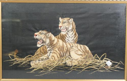 A Japanese embroidered picture of two tigers, early 20th century, 30cm. by 48cm., framed and glazed.