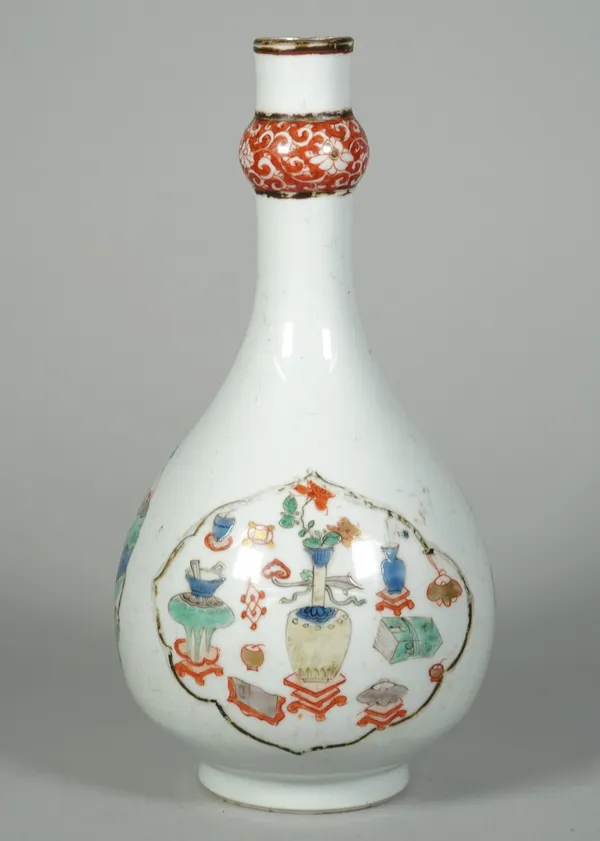 A Chinese famille-verte guglet, Kangxi, enamelled with three shaped panels enclosing precious objects, flowering prunus branches or a mythical creatur