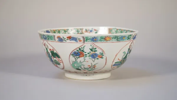 A Chinese famille-verte bowl, Kangxi, painted on the exterior with shaped panels enclosing precious objects alternating with flowering branches, the i