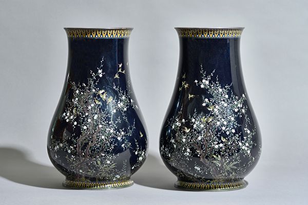 A pair of Japanese cloisonné vases, 20th century, each worked in silver and gold wire with birds amongst flowering branches against a black ground, 37
