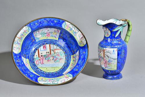 A Canton enamel jug and basin, late 18th/early 19th century,each painted with figurative panels on a rich blue ground scattered with flower sprays and