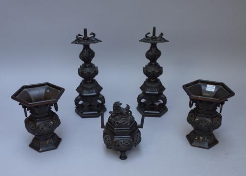 A garniture of Asian bronzes, Chinese or Japanese, circa 1900, comprising; a pair of pricket candlesticks, 23cm. high, a pair of hexagonal small vases