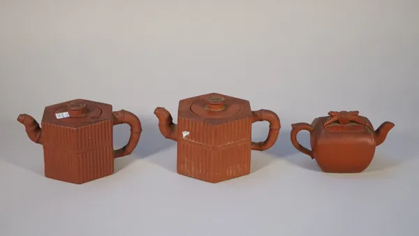 A group of three Chinese Yixing teapots and covers, probably 19th century, two of hexagonal form moulded with diving rods and bamboo section spouts an