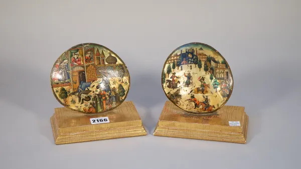 A pair of Qajar paintings on mother-of-pearl shells, late 19th/20th century, one painted with figures outside a palace, the other depicting a polo mat