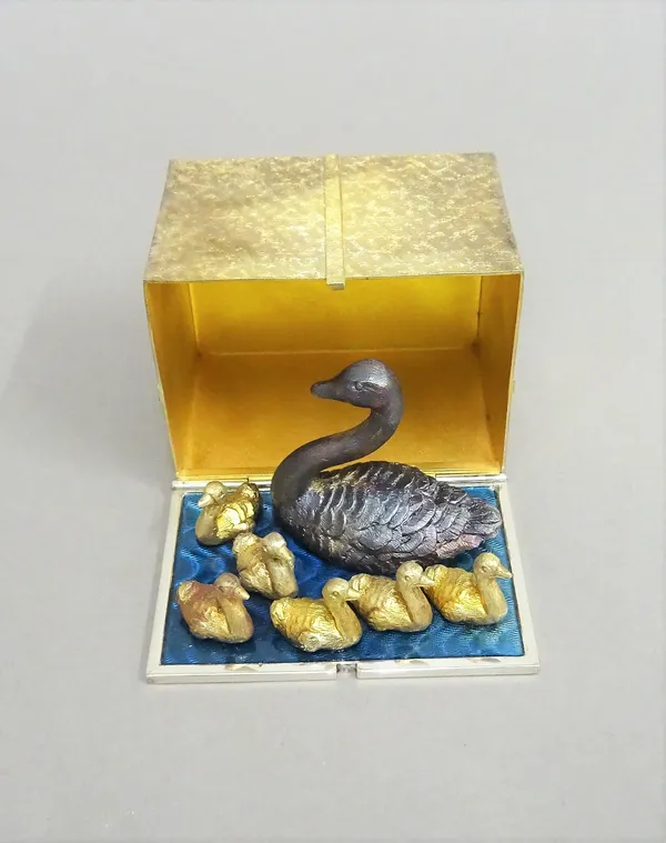 A Stuart Devlin Christmas box, containing a silver gilt, silver and enamelled model representing the seventh day of Christmas, being Seven Swans a Swi
