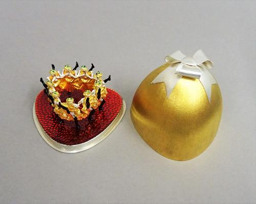 A Stuart Devlin Christmas box, containing a silver gilt, silver and enamelled model representing the ninth day of Christmas, being Nine Ladies Dancing