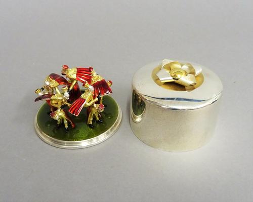 A Stuart Devlin Christmas box, containing a silver gilt and enamelled model representing the tenth day of Christmas, being Ten Lords a Leaping, number