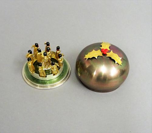 A Stuart Devlin Christmas box, containing a silver gilt, silver and enamelled model representing the eleventh day of Christmas, being Eleven Pipers Pi