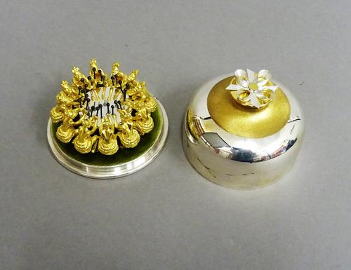 A Stuart Devlin Christmas box, containing a silver gilt and enamelled model representing the twelfth day of Christmas, being Twelve Drummers Drumming,