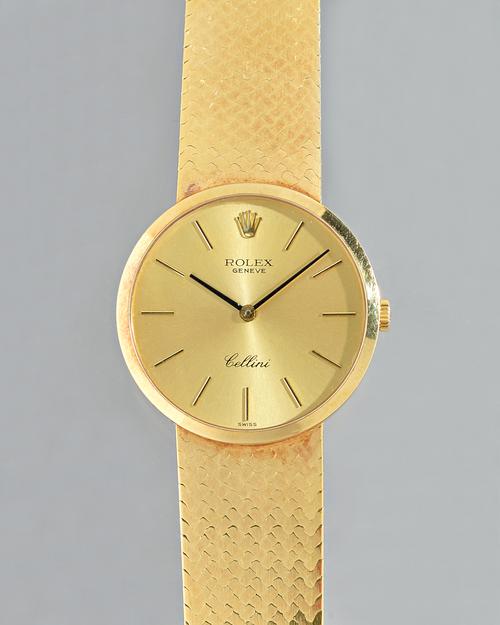 A Rolex Geneve Cellini 18ct gold, circular cased gentleman's bracelet wristwatch, the signed gilt dial with black baton numerals  black hands and with