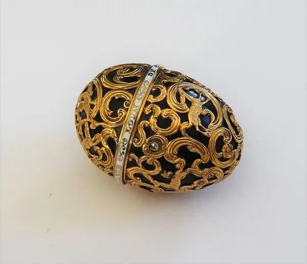 A 19th century gold mounted egg-shaped bloodstone perfume bottle and cover, the scroll cagework casing depicting a hunting scene, the hinged lid and w