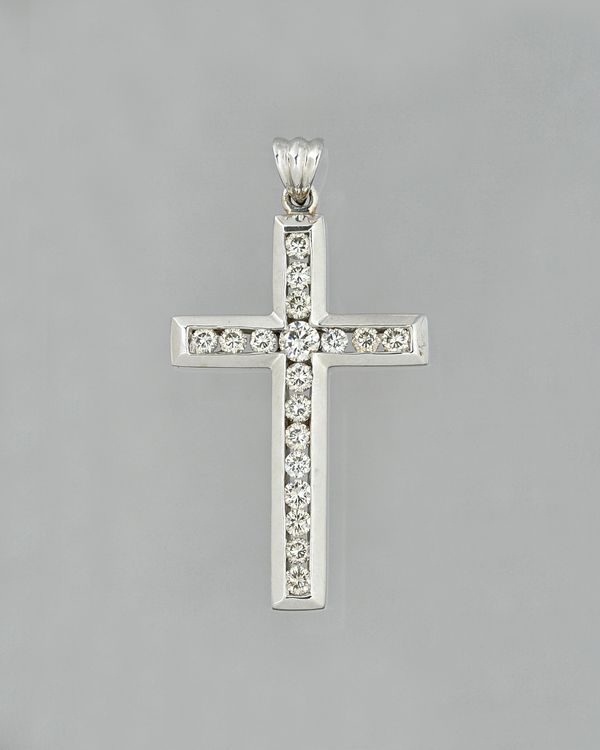 An 18ct white gold and diamond pendant cross, channel set with brilliant cut diamonds, detailed 750 and 18k, gross weight 4.2 gms. Illustrated