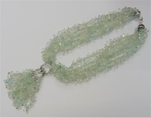 A multi-strand aquamarine pendant necklace, set with six strands of briolette cut sapphires, suspending an oval aquamarine set oval link, further susp