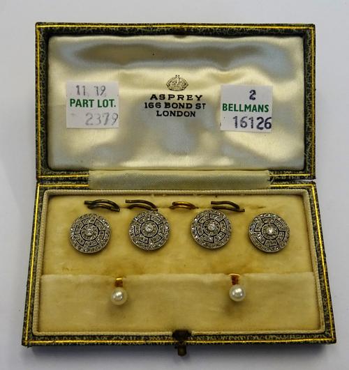 A set of four French platinum and diamond set dress buttons, each collet set with a circular cut diamond to the centre, within a pierced openwork surr