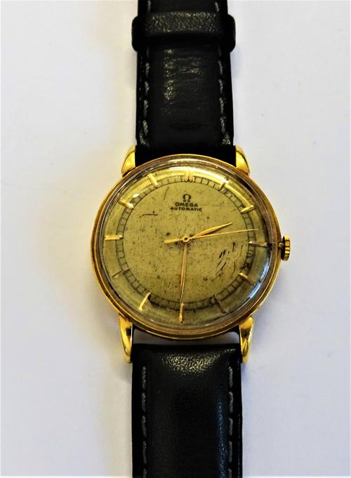 An Omega Automatic gold circular cased gentleman's wristwatch, with a signed jewelled movement numbered 10257584, the signed dial with gilt baton nume