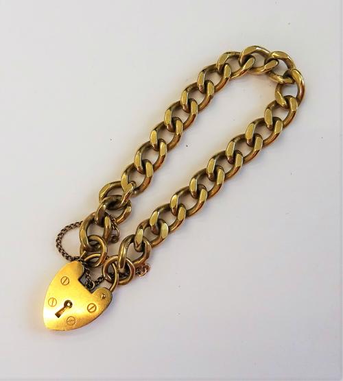 A 9ct gold faceted curb link bracelet, on a 9ct gold heart shaped padlock clasp, weight 28.8 gms.