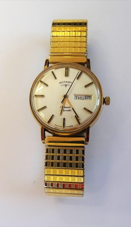 A Rotary Automatic 9ct gold circular cased gentleman's wristwatch, the signed silvered dial with black baton numerals, day of the week and date of the