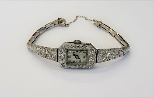 A platinum and diamond set lady's dress wristwatch, the rectangular silvered dial with black Arabic numerals, the jewelled movement detailed COBDEN, t