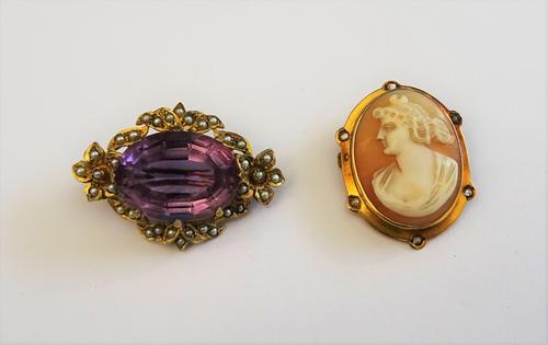 A 9ct gold, amethyst and seed pearl set brooch, claw set with the oval cut amethyst to the centre, within a seed pearl set surround, having two floral