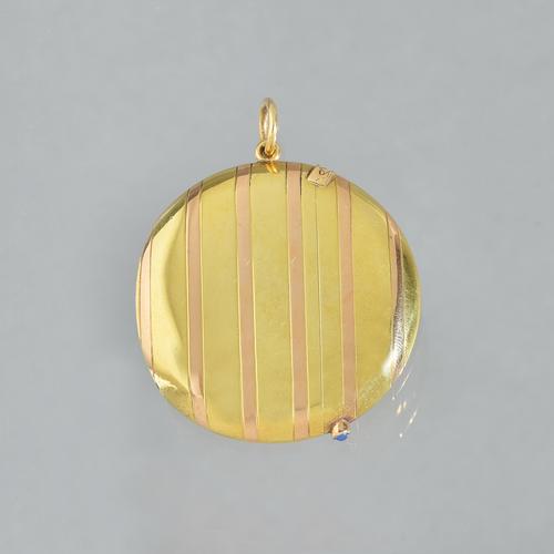 A French two colour gold vesta case, of circular form with banded decoration and with a moonstone set thumbpiece, the side fitted with a suspension lo