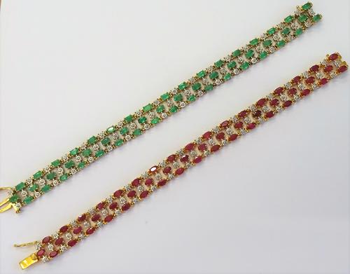 A silver gilt and ruby bracelet, in a three row design, claw set with oval cut rubies, on a snap clasp, detailed Metal, with a foldover safety catch a