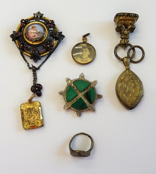 A 19th century brooch, mounted with the portrait of a putto to the centre within a carbuncle garnet set surround, a malachite set brooch, an oval pend