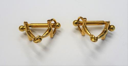 A French pair of gold cufflinks, designed as mouth bits for horses bridles, the backs with folding bar fittings, gross weight 11.7 gms, with an associ