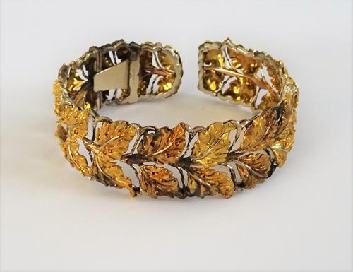 A cuff bracelet by Buccellati, of naturalistic leaf design, the wide openwork cuff, with matt finish yellow leaves and highly polished leaf veins, the