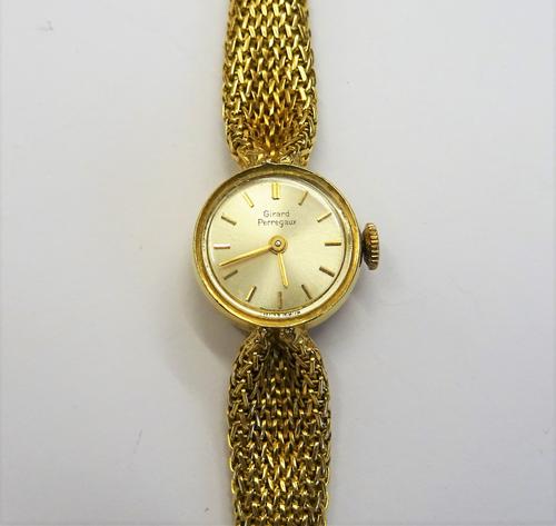 A Girard Perregaux lady's gold bracelet wristwatch, the signed circular silvered dial with gilt baton numerals, the caseback detailed 78320006,  on a