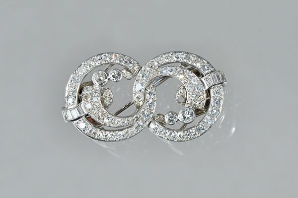 A white precious metal and diamond set double clip/brooch, of figure of eight design, set with circular and baguette cut diamonds, gross weight 16.4gm
