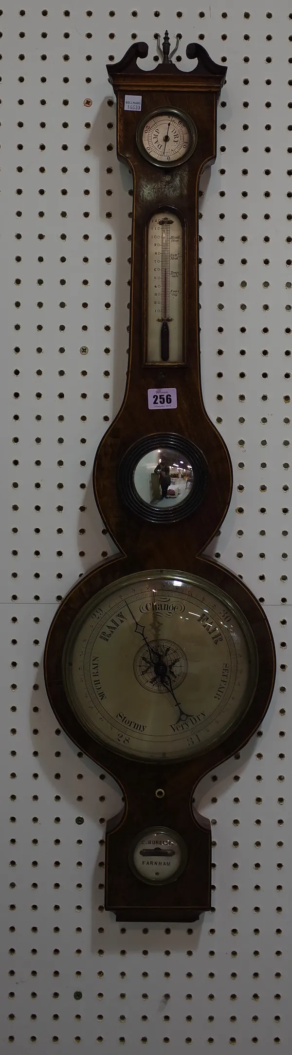 A late Regency mahogany wheel barometer by C. Borelli, Farnham, with swan neck pediment above hygrometer, thermometer and small convex mirror, with 8i