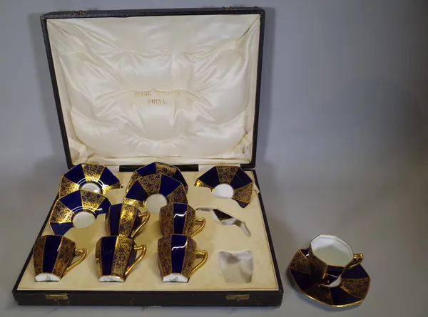 A Royal Doulton twelve piece coffee set, cased, with blue and gilt decoration.