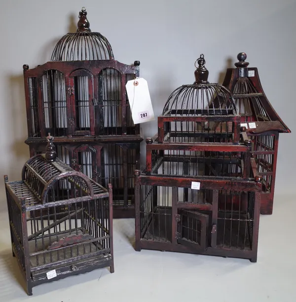 A group of four 20th century black lacquer and hardwood bird cages of various forms, the largest, 32cm wide x 61cm high, (4).