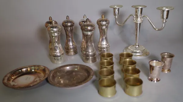 A large quantity of 20th century silver and plated pepperettes, napkin rings and sundry, (qty).