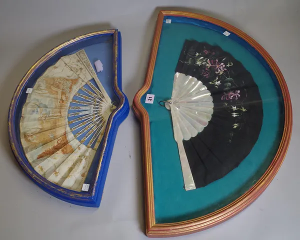 An 18th century framed paper fan, hand painted with classical scenes, over pierced gilt ivory sticks, 27cm and a mother-of-pearl fan also framed, (2).