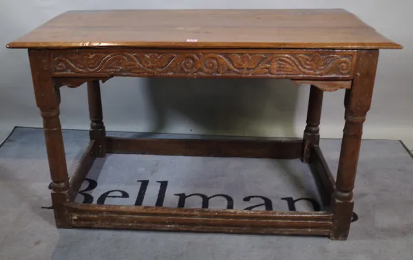 An 18th century oak side table on turned block supports, 122cm wide x 73cm high.