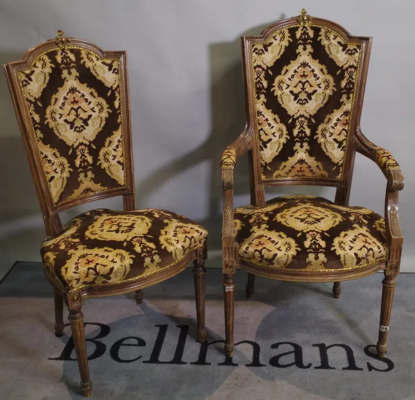 A set of six 20th century Louis XVI style stained beech dining chairs, with gilt metal crest finials on flared tapering supports, to include two carve