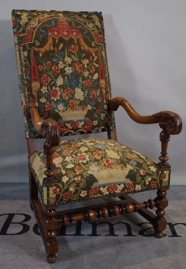 A Victorian oak framed open armchair on block supports.