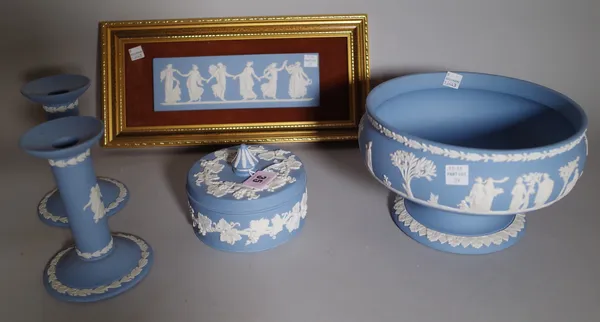 A group of Wedgwood blue jasper, 20th century, comprising; a bowl sprigged with classical figures, 20.5cm. diameter; a pair of cylindrical candlestick