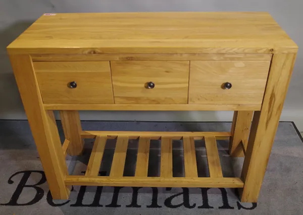 A modern oak side table with three drawers, united by undertier, 100cm wide x 80cm high.