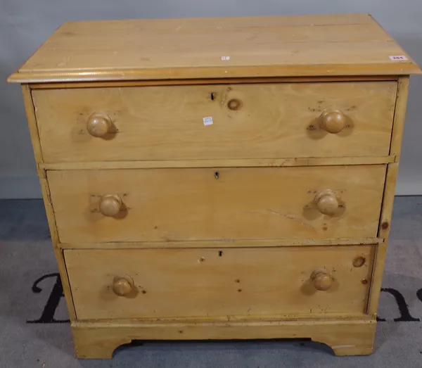 A late Victorian pine chest of three long drawers on bracket feet.