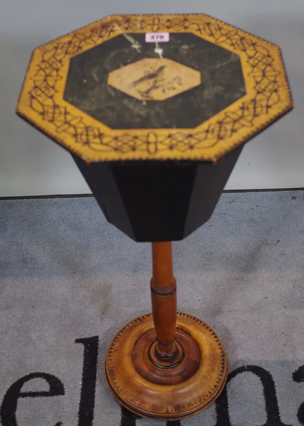 A late Victorian stained pine and ebonised octagonal sewing table of tapering form on circular plinth base.