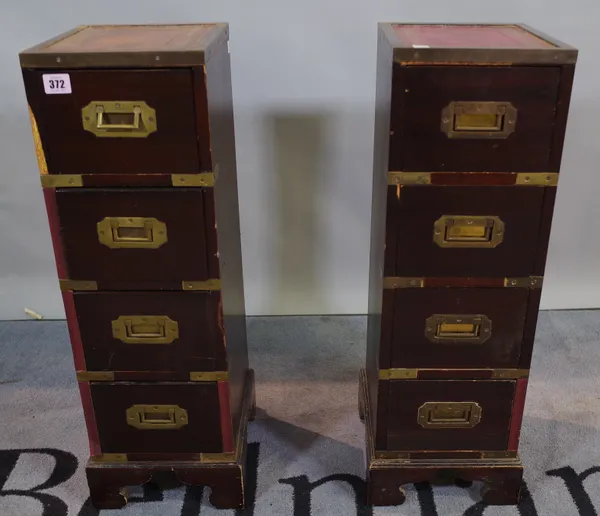 A pair of campaign style brass bound hardwood four drawer pedestals, 22cm wide x 69cm high, (2).