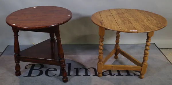 An early 20th century oak cricket table on barley-twist supports, 68cm wide x 60cm high and another later oak circular table, 61cm wide x 63cm high, (