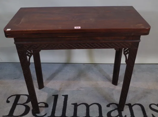 A late George III mahogany fold over card table with fret cut decoration, 80cm wide x 73cm high.