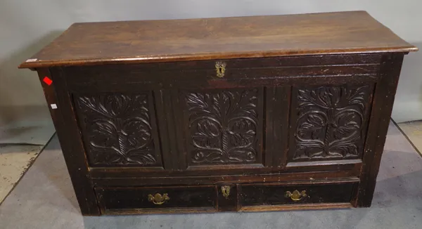 An 18th century and later oak coffer with three inset carved panels over two drawers, 134cm wide x 72cm high.